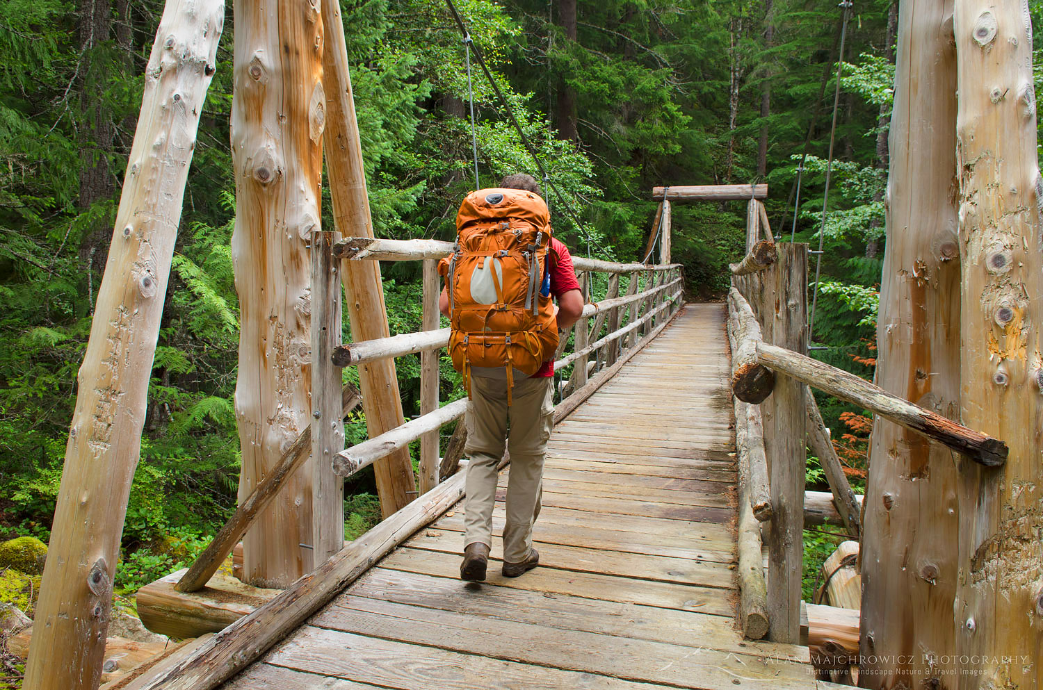 Hiker on suspension bridge Suiattle River Trail North Cascades