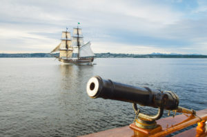 Lady Washington at sail in Semiahmoo Bay, Washington. A historic replica of the original 18th Century brig. Owned and operated by the Grays Harbor Historical Seaport, Aberdeen, Washington. 3 pound gun swivel mounted gun on the Hawaiian Chieftain is in the foreground.