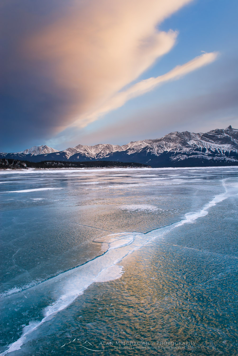 Clouds glowing in a winter sunset over the wind polished ice of Abraham Lake, Alberta Canada #43546