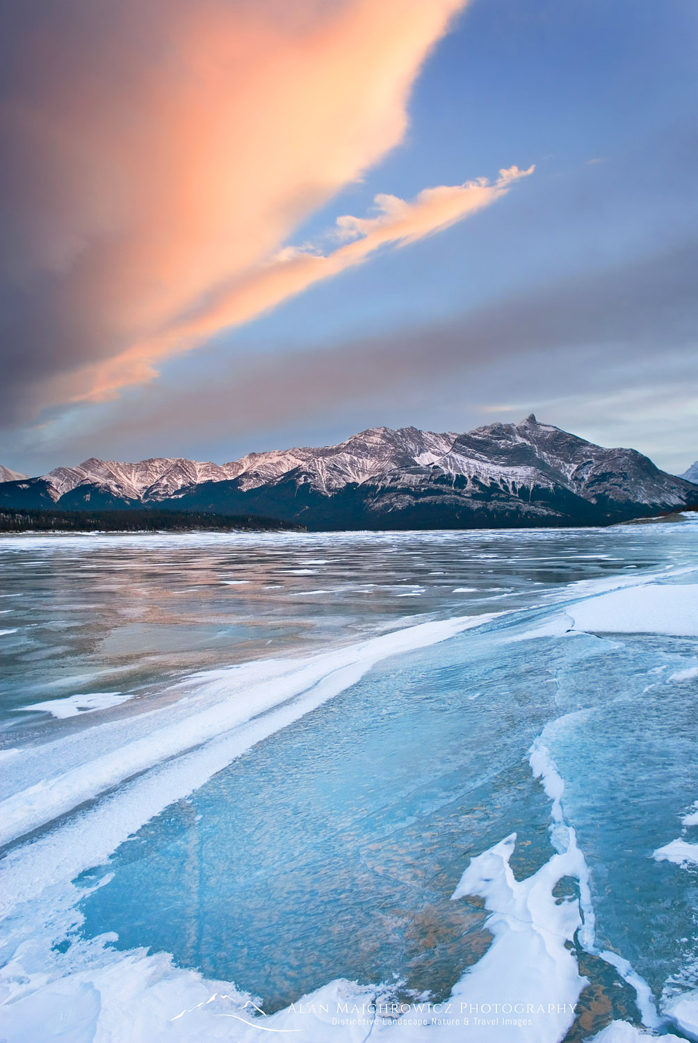 Clouds glowing in a winter sunset over the wind polished ice of Abraham Lake, Alberta Canada #43562