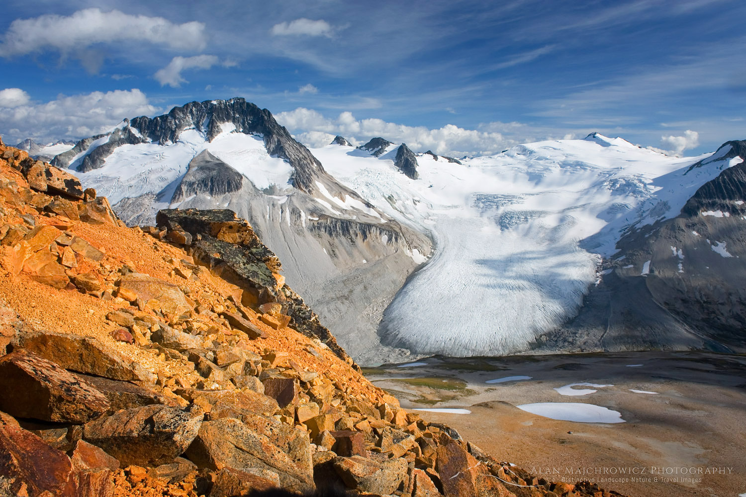 Tongue-like glacier flowing down between Mount Ethelweard (left) 2819 m (9249 ft) and Icemaker Mountain 2745 m (9006 ft). Seen from Ochre Mountain above Athelney Pass. Coast Mountains British Columbia Canada #18242