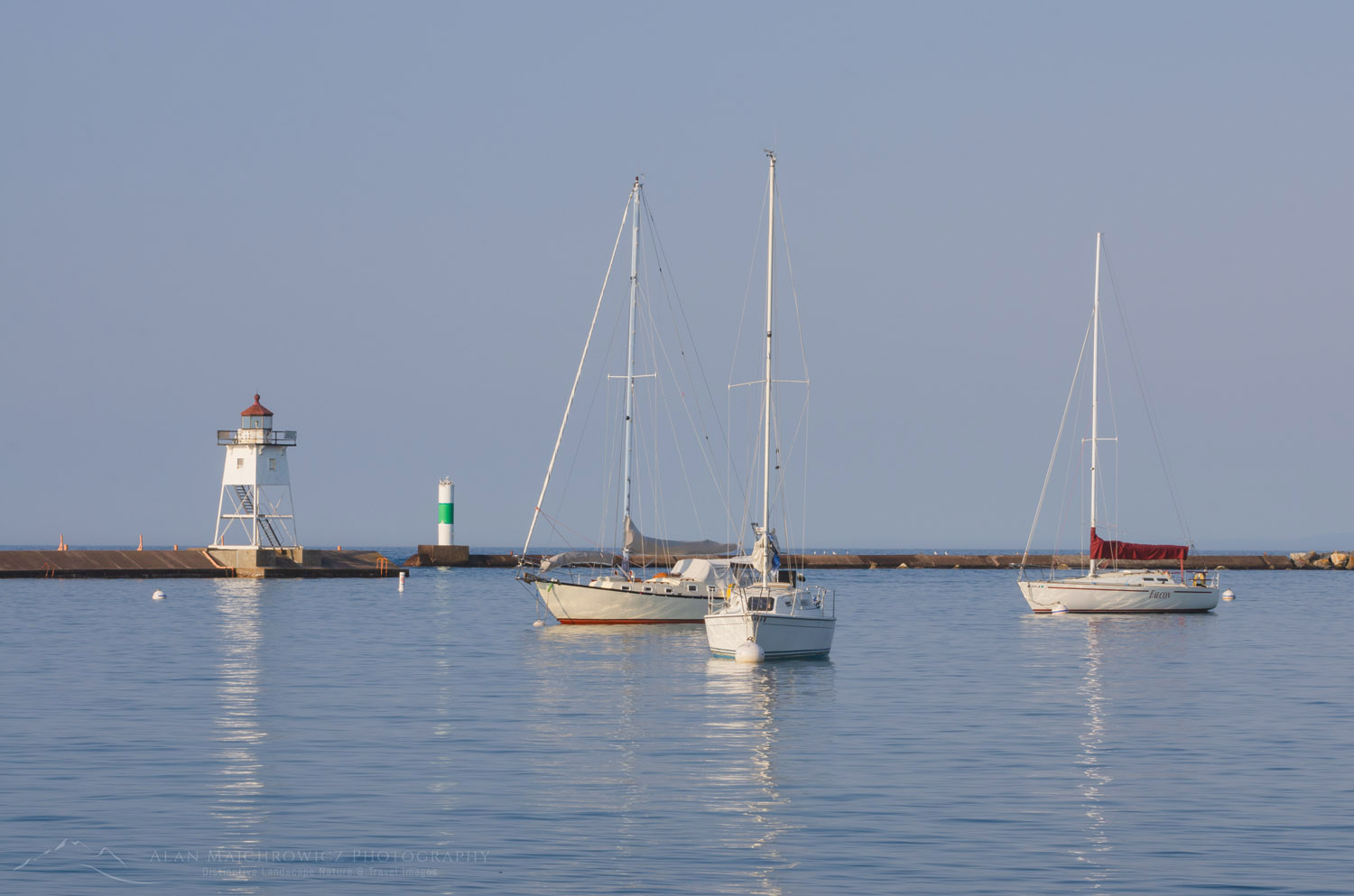 Grand Marais Lighthouse and sailboats moored in Grand Marais Harbor. North Shore of Lake Superior. Grand Marais, Minnesota #64135