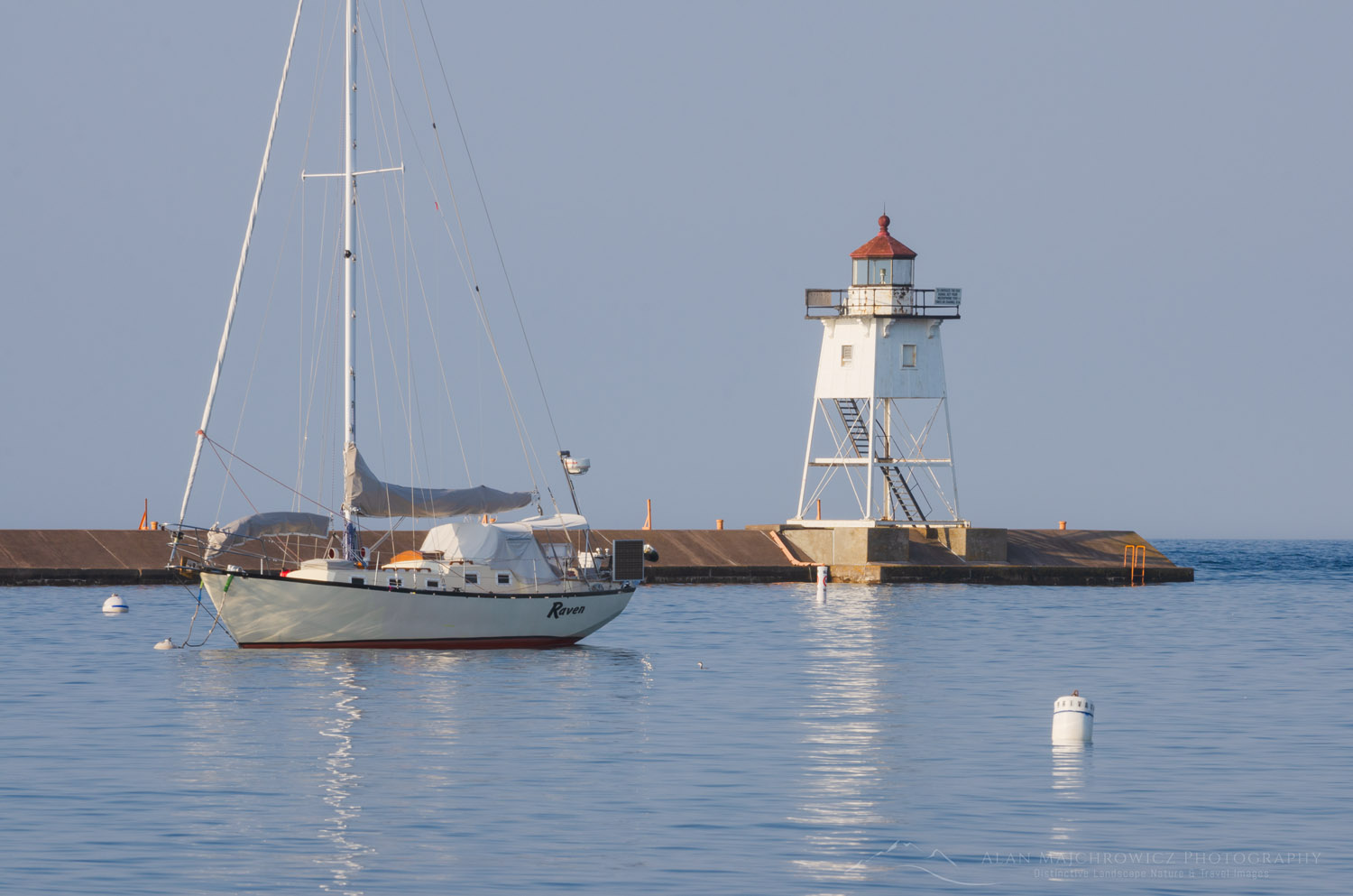 Grand Marais Lighthouse and sailboats moored in Grand Marais Harbor. North Shore of Lake Superior. Grand Marais, Minnesota #64137