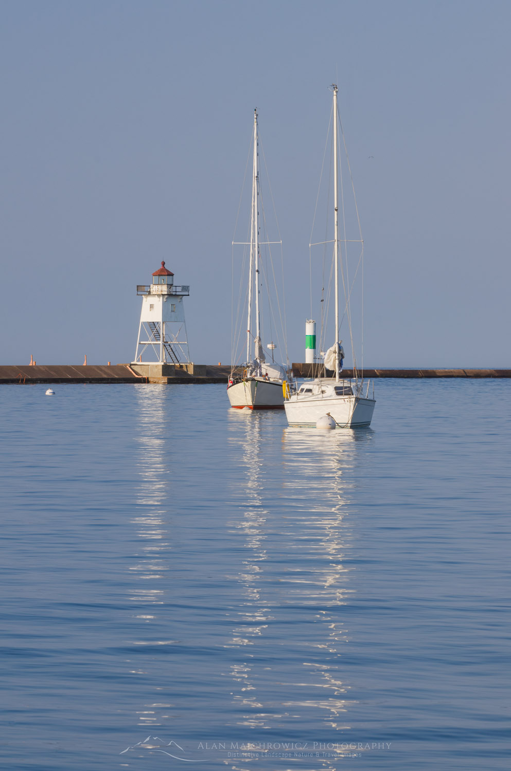 Grand Marais Lighthouse and sailboats moored in Grand Marais Harbor. North Shore of Lake Superior. Grand Marais, Minnesota #64141