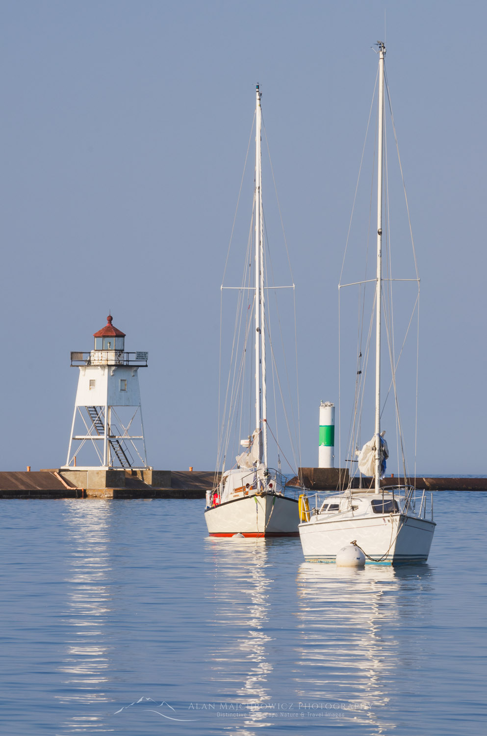 Grand Marais Lighthouse and sailboats moored in Grand Marais Harbor. North Shore of Lake Superior. Grand Marais, Minnesota #64142