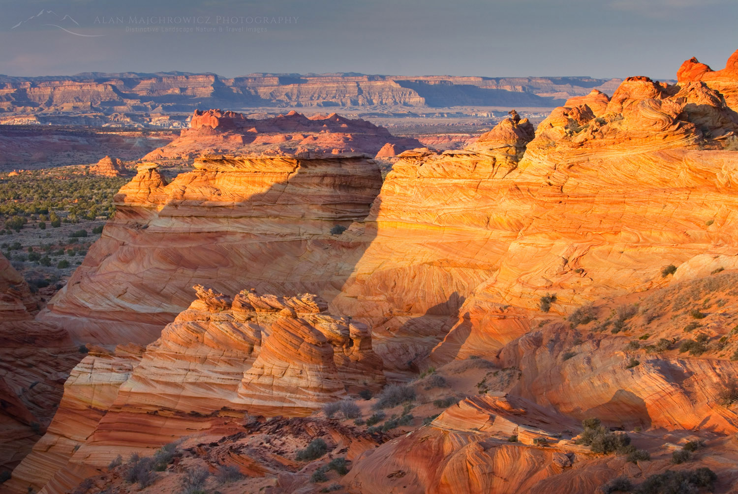 Setting sun illuminating cross-bedding in sandstone buttes of South Coyote Buttes, Vermilion Cliffs Wilderness Arizona #37814
