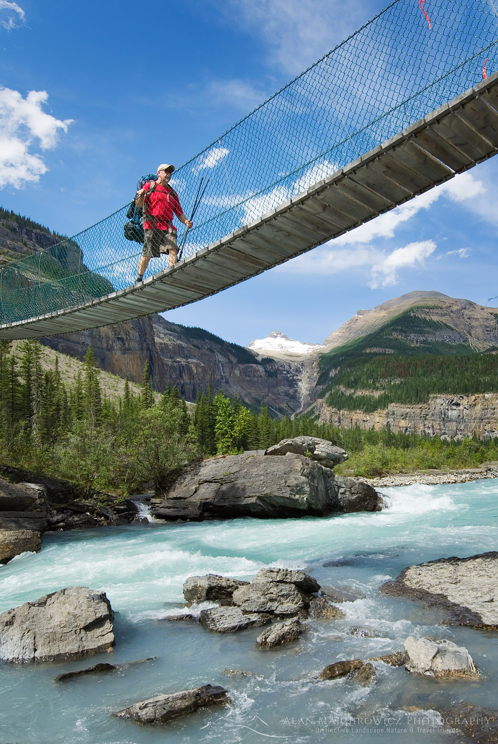 Hiker crossing suspension bridge on the Berg Lake Trail, Mount Robson Provincial Park British Columbia Canada #45467