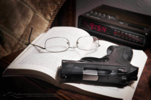 Beretta PX4 Storm semi-automatic pistol with 9mm ammunition on bedroom nightstand