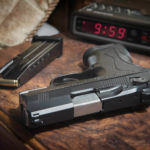 Beretta 9mm Px4 Storm semi-automatic pistol home defense. On bedside nightstand with book and reading glasses