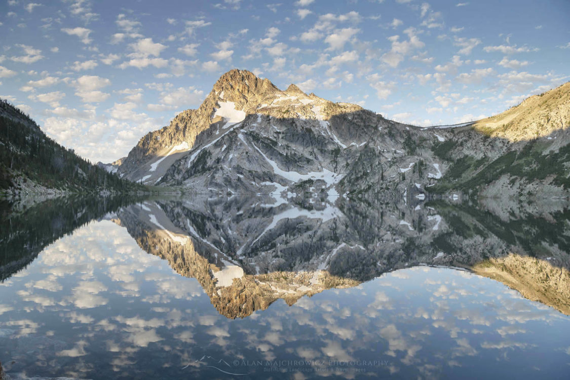 Mount Regan mirrored in still waters of Sawtooth Lake at sunrise. Sawtooth Mountains Wilderness Idaho