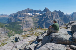 Backpacker at Boulder Pass . Thunderbird Mountain is in the distance. Glacier National Park Montana