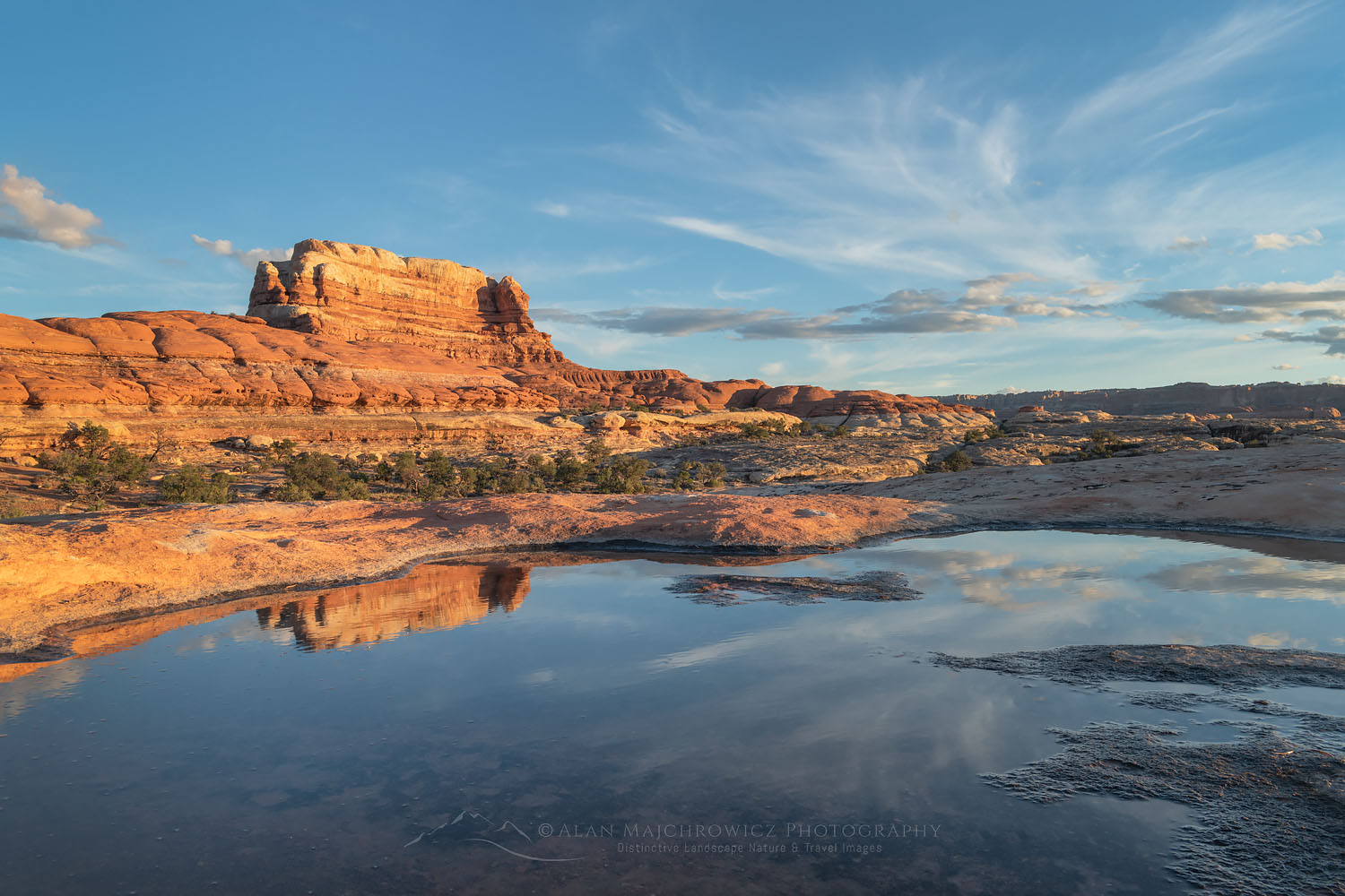 Sandstone butte reflected in water filled potholes on slickrock mesa, Needles District, Canyonlands National Park Utah #74644