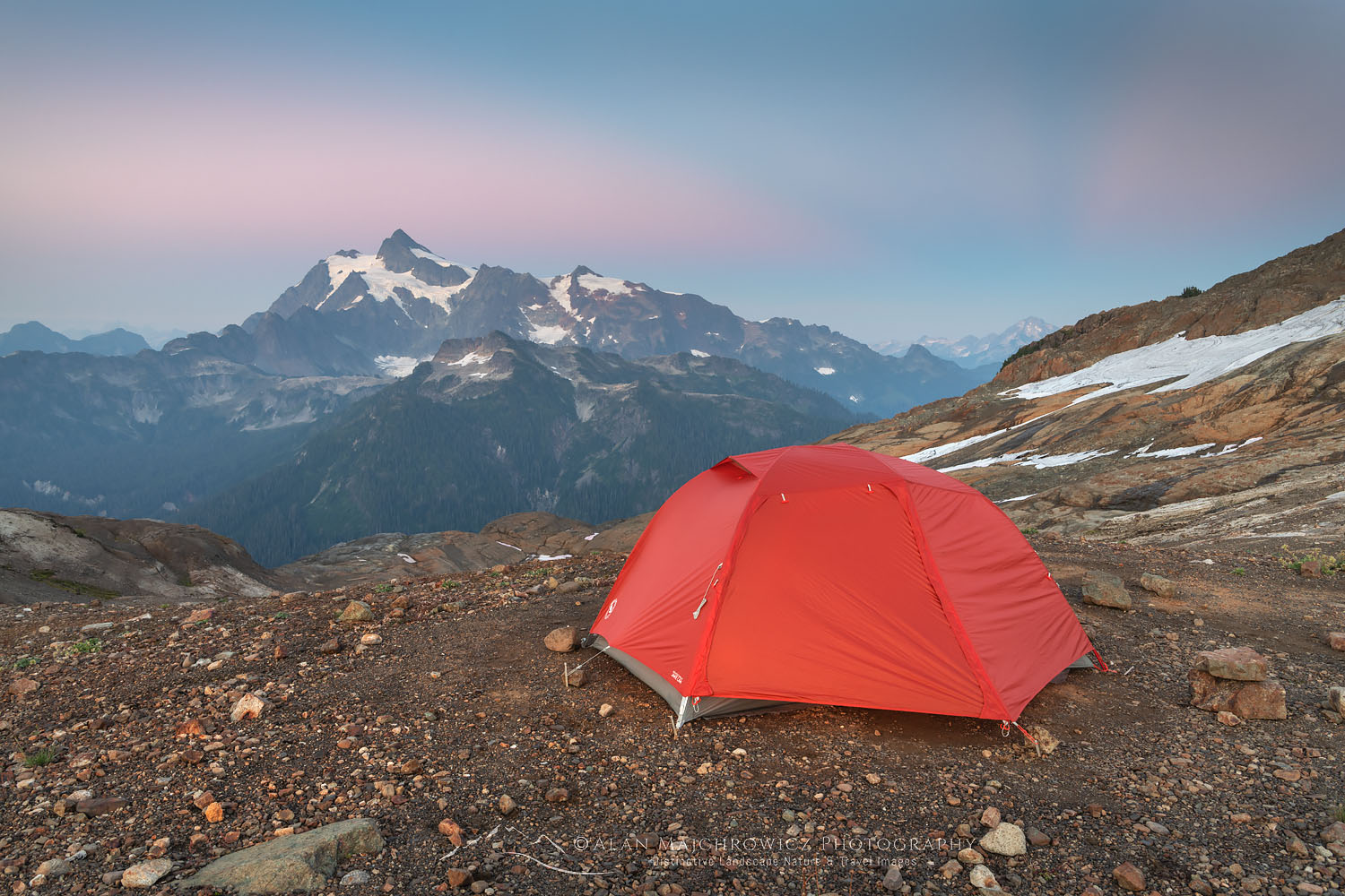 Red backpacking tent at backcountry camp on Ptarmigan Ridge. Mount Shuksan is in the distance. Mount Baker Wilderness. North Cascades Washington #73648