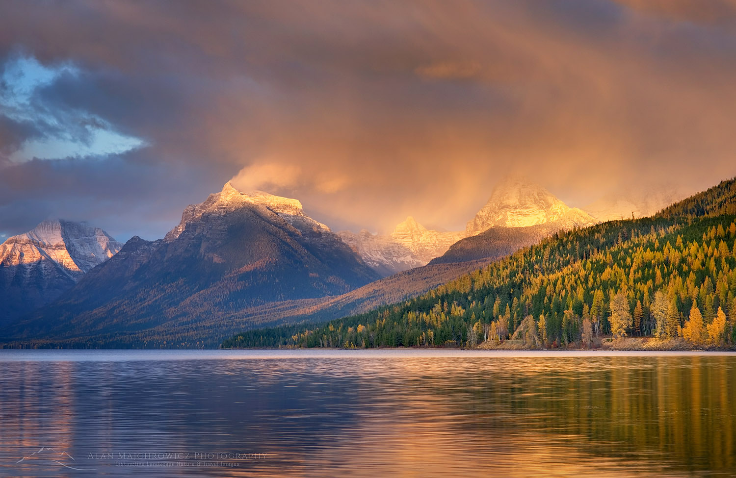 Curtains of rain showers from a passing autumn storm glow in the evening light above Lake McDonald, Glacier National Park Montana #22797