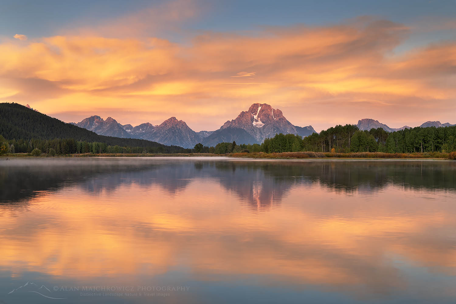 Orange clouds and Mount Moran reflected in still waters of the Snake River at Oxbow Bend at sunrise, Grand Teton National Park Wyoming #67699