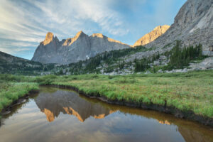 Cirque of the Towers reflected in stream flowing into Lonesome Lake, Popo Agie Wilderness Wind River Range Wyoming