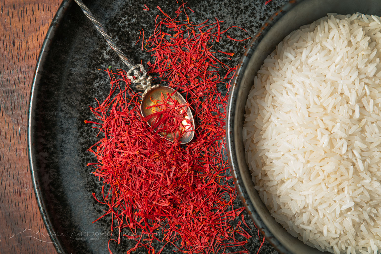 Culinary still life with saffron and jasmine rice on earthenware plates and bowls and antique spoon #79030