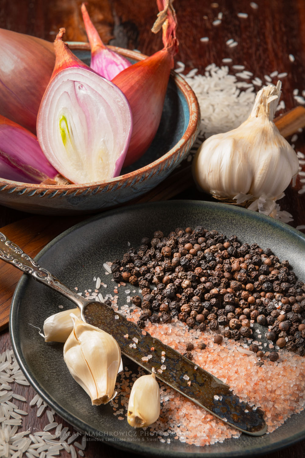 Still life with shallots, garlic, peppercorns, and pink sea salt on stoneware with antique knife #79046