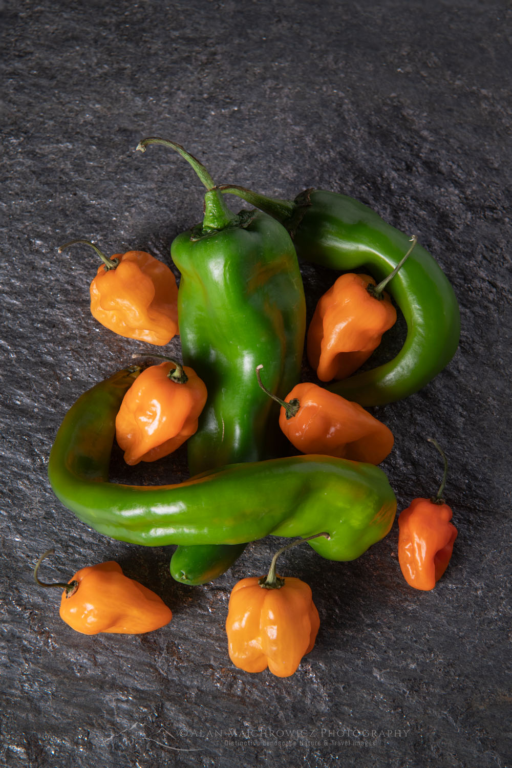 Arrangement of Habanero and Hatch Chile peppers on stone backdrop #81153