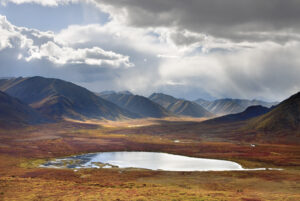 Stormy sky reflected in small lake, Tombstone Territorial Park Yukon Canada