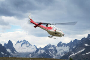 Helicopter lifting off Rocky Point Ridge, Bugaboos in the distance. Bugaboo Provincial Park, Purcell Mountains British Columbia. #62947