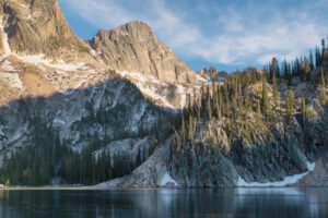 Sevy Peak and Mount Cramer are reflected in the still waters of Upper Cramer Lake. Sawtooth Wilderness, Idaho #83609