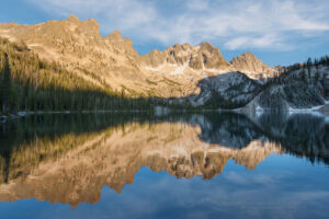 Sevy Peak and Mount Cramer are reflected in the still waters of Upper Cramer Lake. Sawtooth Wilderness, Idaho #83611
