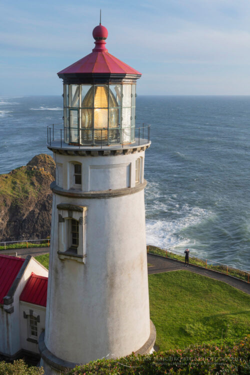 Woman with cell phone photographing Heceta Head Lighthouse, Oregon #83148