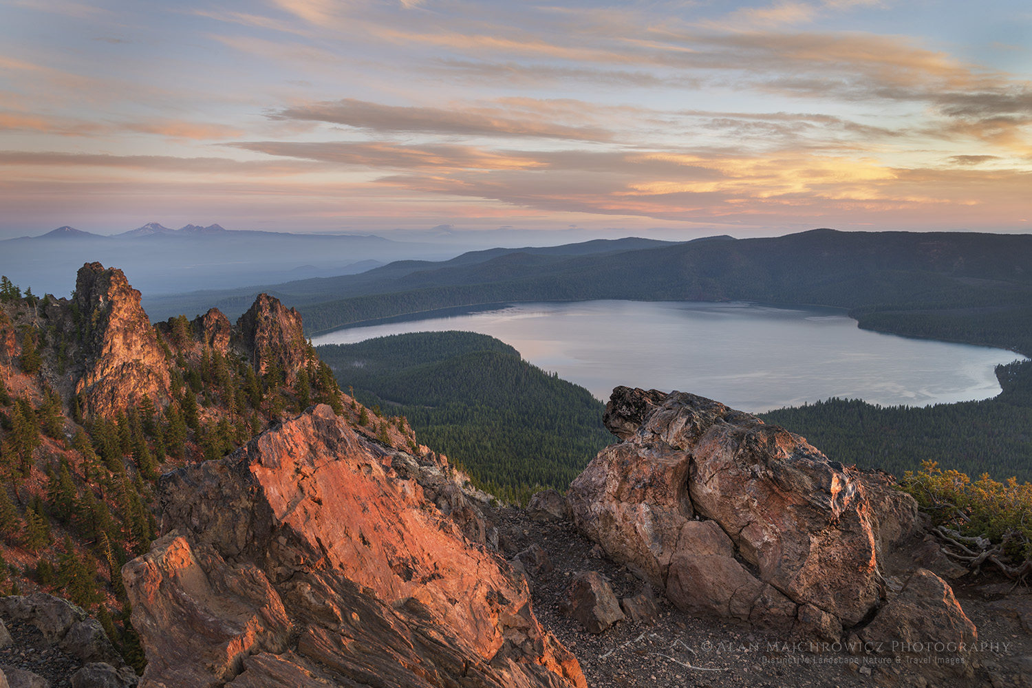 Dramatic sunrise sky over Paulina Lake and Cascade Range is seen from the Paulina Peak overlook. Newberry National Volcanic Monument, Oregon #84085
