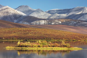 Lake in the Blackstone Plateau reflected clouds and hills of the Ogilvie Range, Yukon, Canada #15390