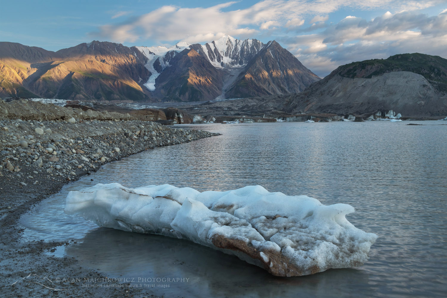 Icebergs stranded on debris at the ice-marginal lake of Kaskawulsh Glacier. Mount Maxwell is in the distance. Ä’äy Chù (Slim's River) West, Kluane National Park, Yukon #86736