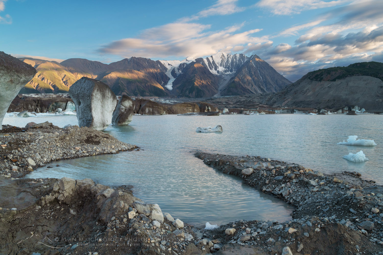 Icebergs stranded on debris at the ice-marginal lake of Kaskawulsh Glacier. Mount Maxwell is in the distance. Ä’äy Chù (Slim's River) West, Kluane National Park, Yukon #86738