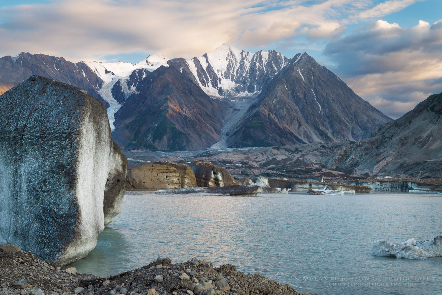 Icebergs stranded on debris at the ice-marginal lake of Kaskawulsh Glacier. Mount Maxwell is in the distance. Ä’äy Chù (Slim's River) West, Kluane National Park, Yukon #86740