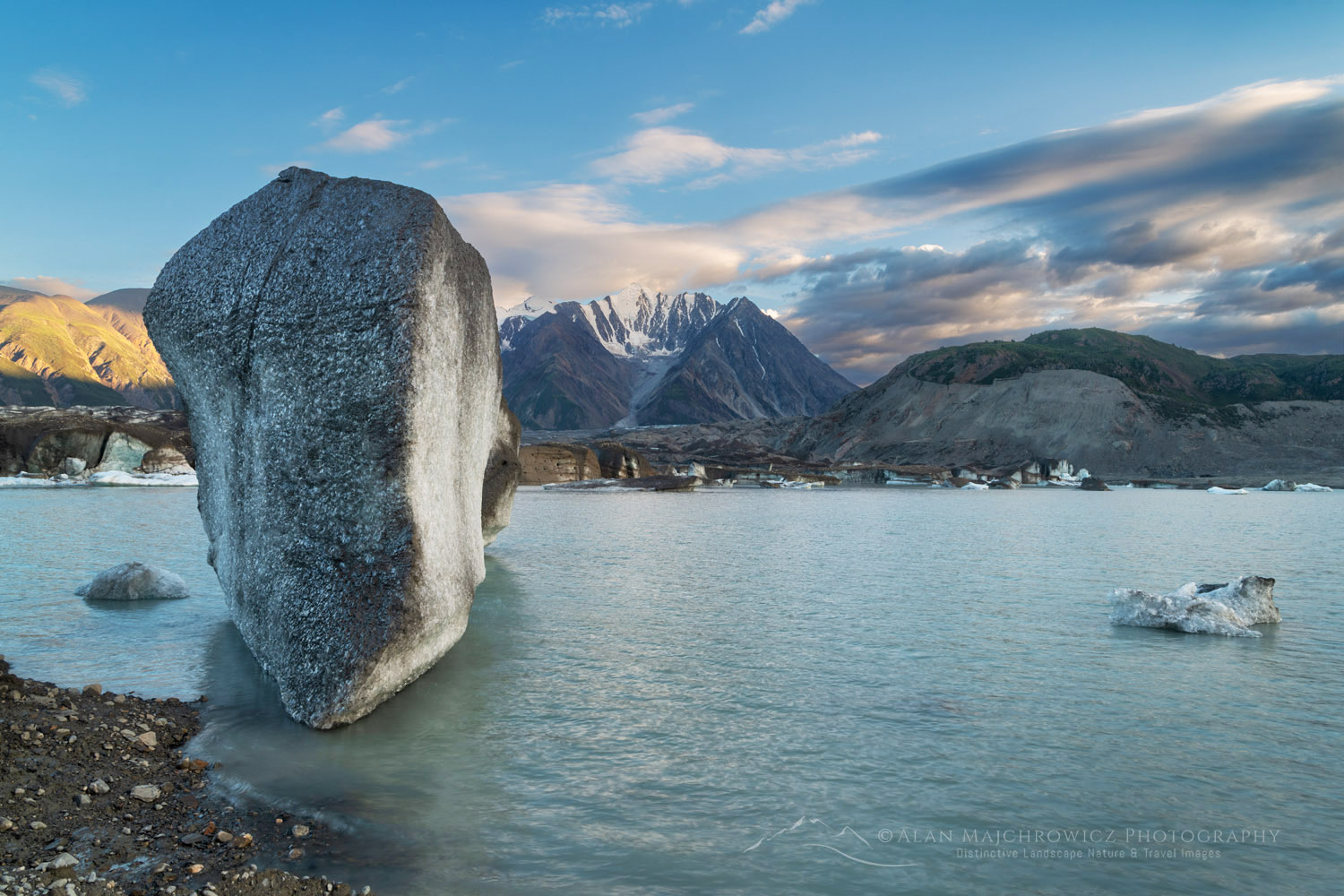Icebergs stranded on debris at the ice-marginal lake of Kaskawulsh Glacier. Mount Maxwell is in the distance. Ä’äy Chù (Slim's River) West, Kluane National Park, Yukon #86743