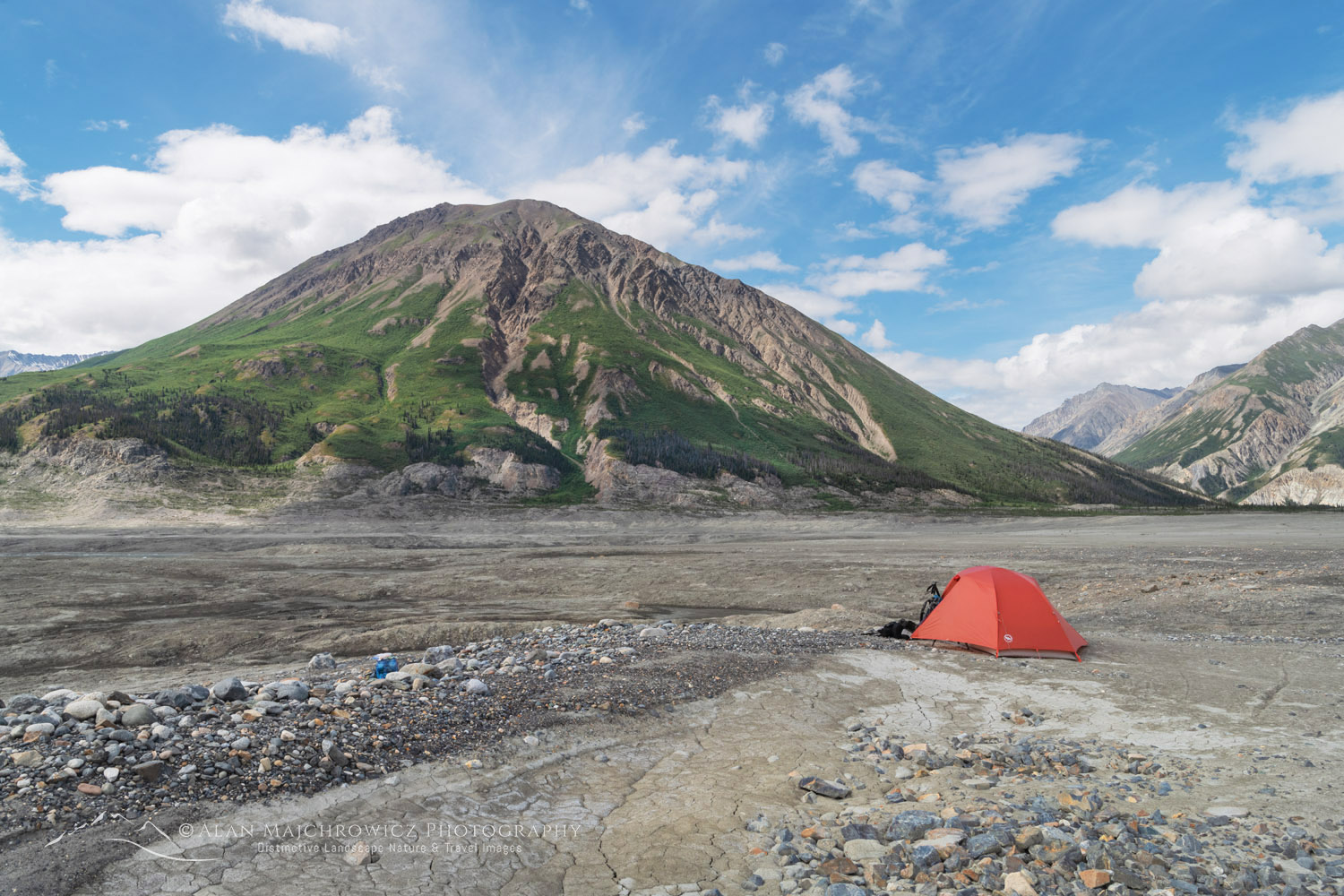 Red tent on the debris fields at the toe of the Kaskawulsh Glacier. Observation Mountain is in the distance. Ä’äy Chù (Slim's River) West, Kluane National Park, Yukon #86717