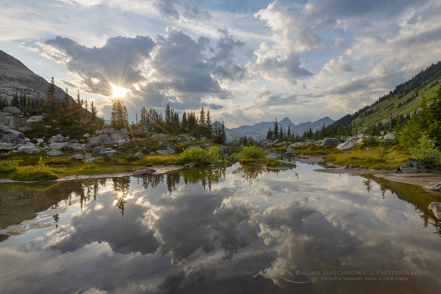 Dramatic clouds reflected in a pond in the alpine basin of Mount Rohr. Coast Range British Columbia #87124